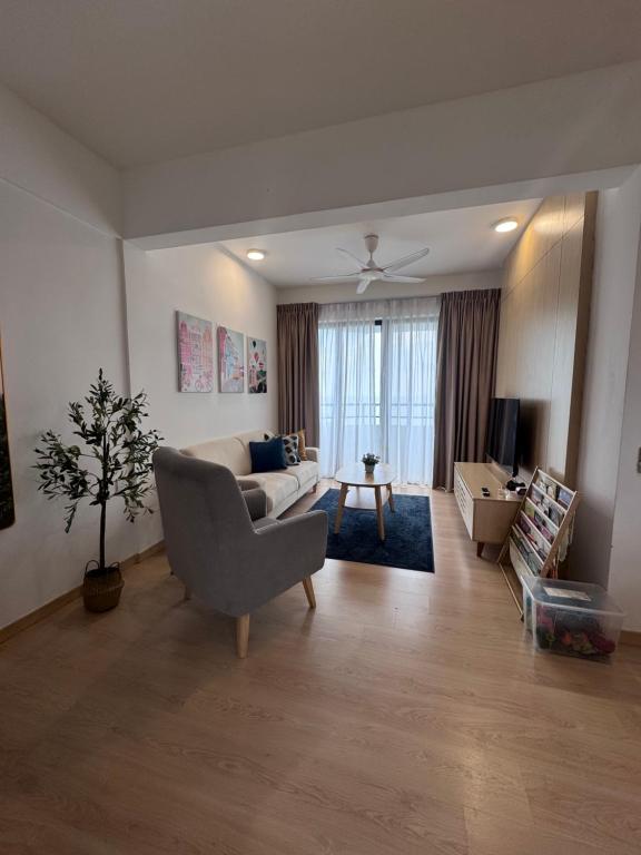 a living room with a couch and a table at SEAVIEW - BEACHFRONT - 2BR Apartment - Corner Unit- Mutiara Melaka Beach Resort Pantai Puteri in Melaka