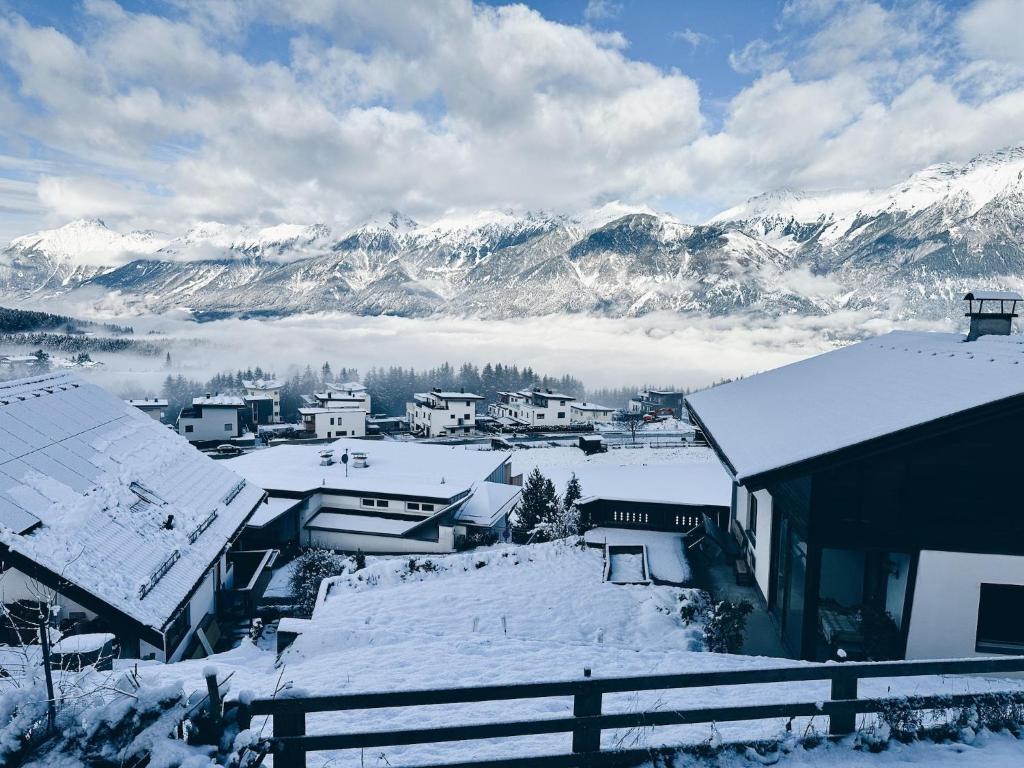 a town covered in snow with mountains in the background at Holiday home with panoramic view in Kleinvolderberg