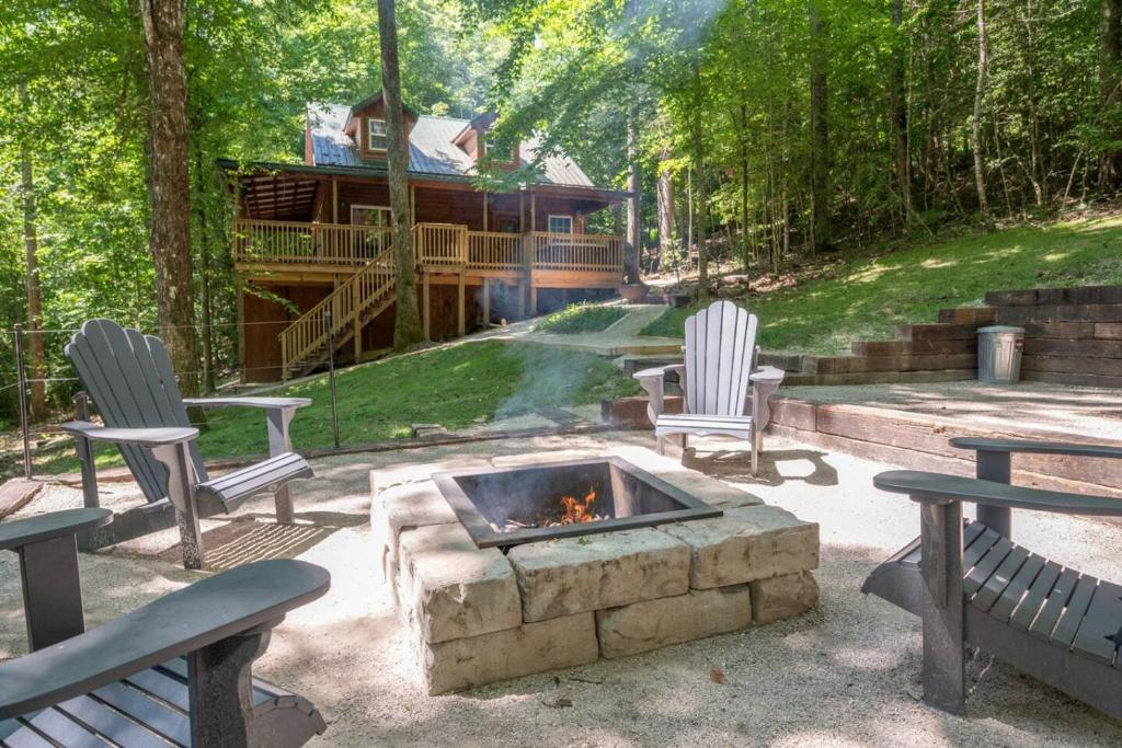 a fire pit with two chairs and a house at WiFi & Hot Tub Large Family - Climb On in RRG in Rogers