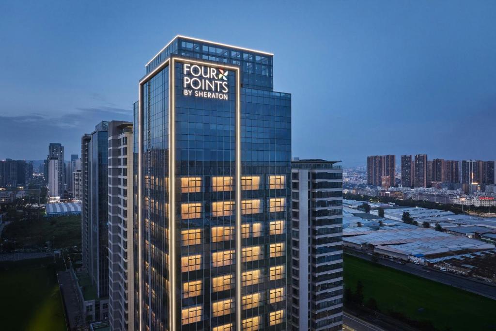 a tall building with a trump towers sign on it at Four Points by Sheraton Kunming Guandu in Kunming