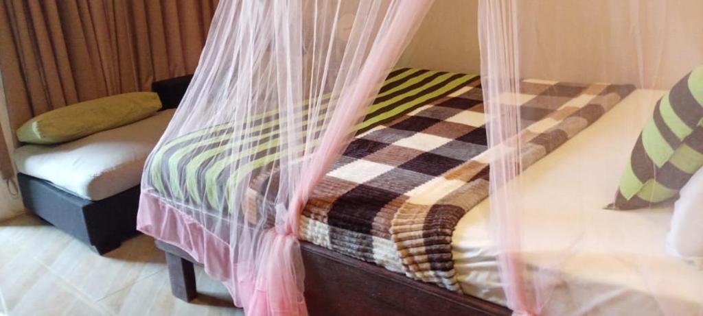 a bed with a canopy in a room at Talblick Valley in Ella