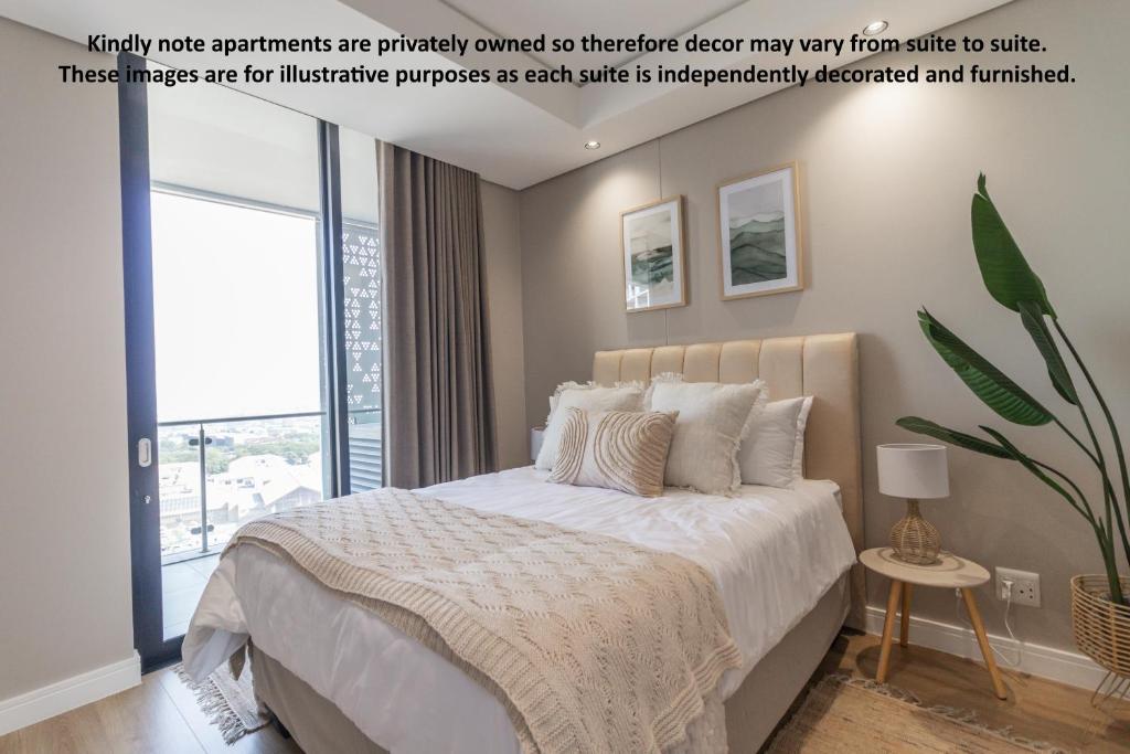 a bedroom with a bed and a large window at Hospitality at Waterfall City - Ellipse Waterfall in Midrand