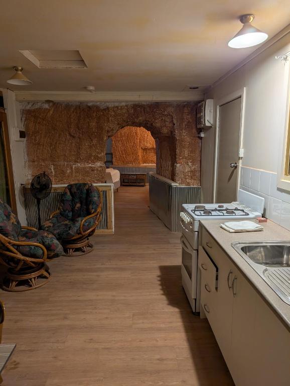 a kitchen with a sink and a stove top oven at Desert Gum Grund st in Coober Pedy