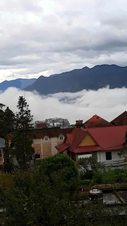 a group of houses with mountains in the background at Sapa Tatu Homestay in Sapa