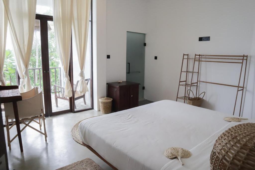 Ένα ή περισσότερα κρεβάτια σε δωμάτιο στο The Banyan Ahangama