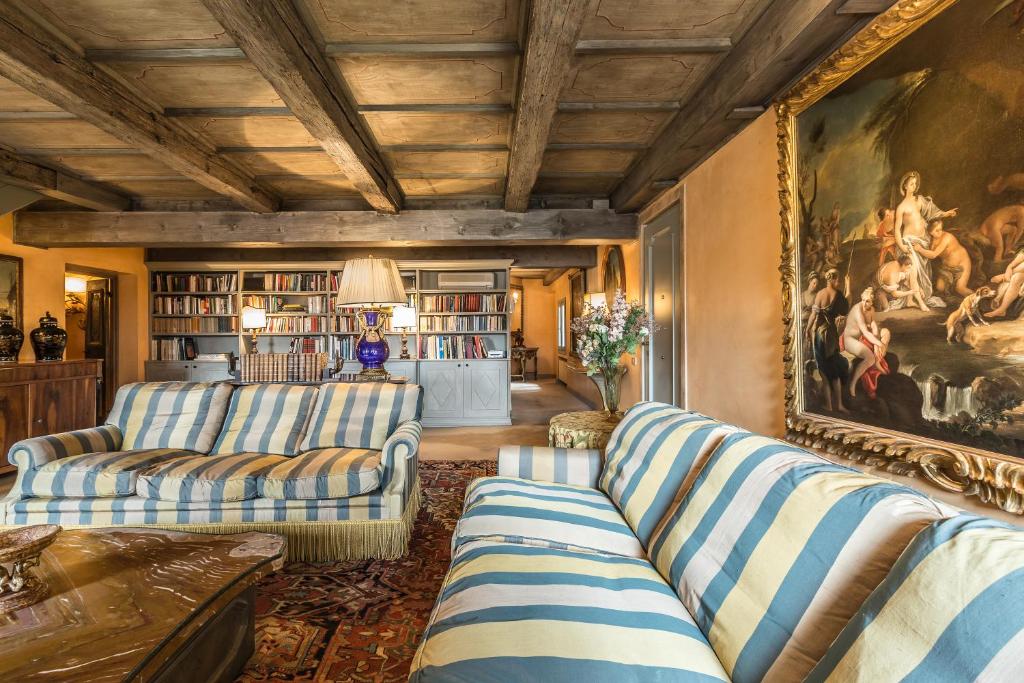 a living room with two couches and a painting on the wall at The Venetian Penthouse in Venice