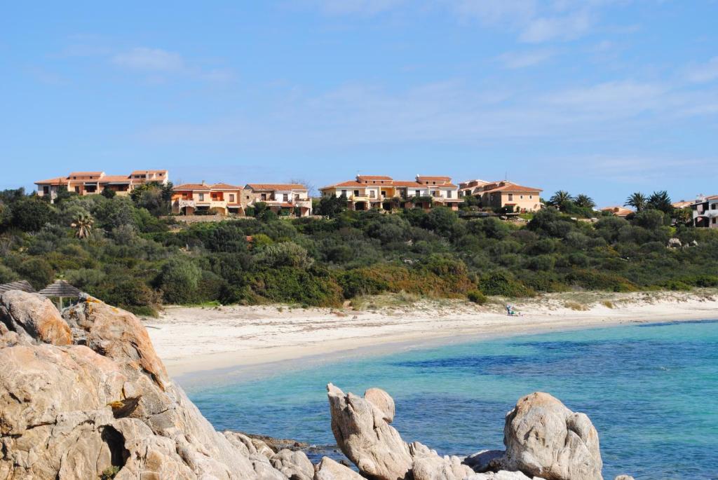 vistas a una playa con casas en una colina en Appartamenti Spiaggia Bianca, en Golfo Aranci