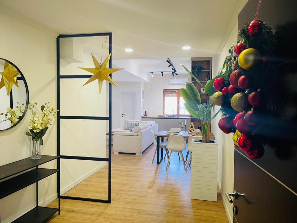 a living room with a christmas tree and a dining room at Gjirokastra Design Apartments in Gjirokastër
