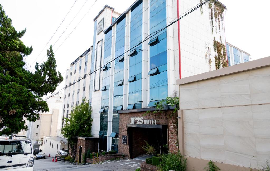 a front view of a building with a parking garage at hotel No25 in Incheon