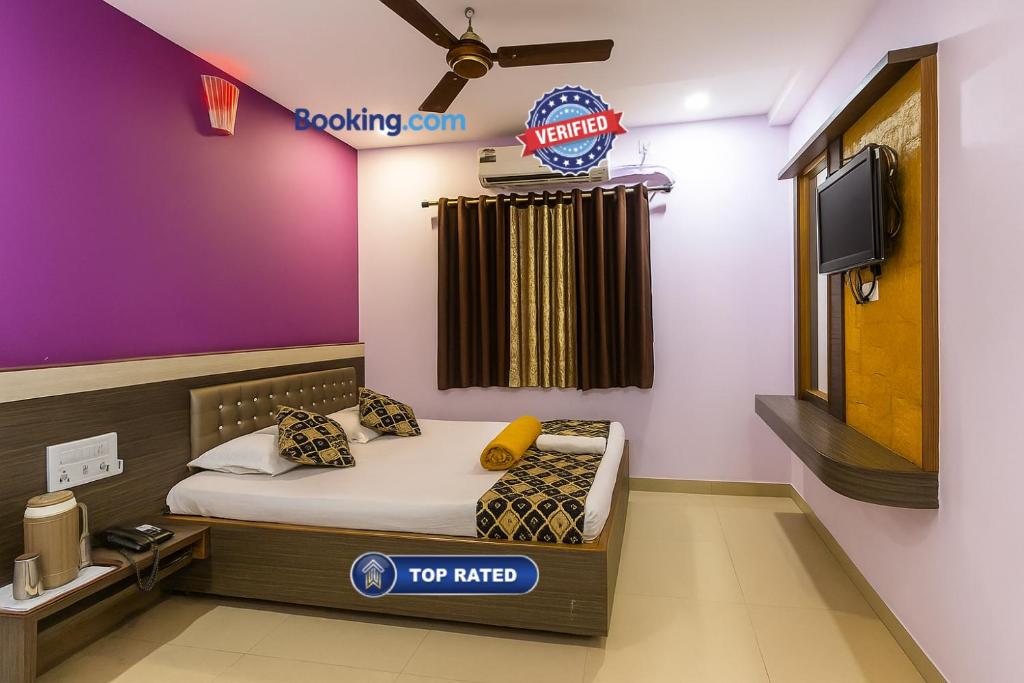 a room with a bed with a top rated sign on the wall at Hotel S B Residency Near Shri Sai Baba Temple - Fully Air conditioned Room - Free Wifi And parking Available - Best Premium Hotel In Shirdi in Shirdi