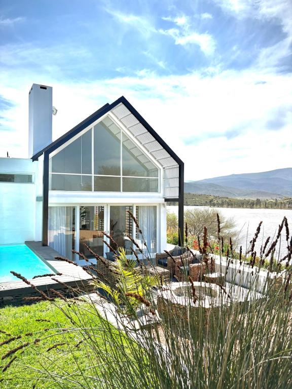 a house on the beach with a pool at Fish Eagle House on the Dam in Montagu