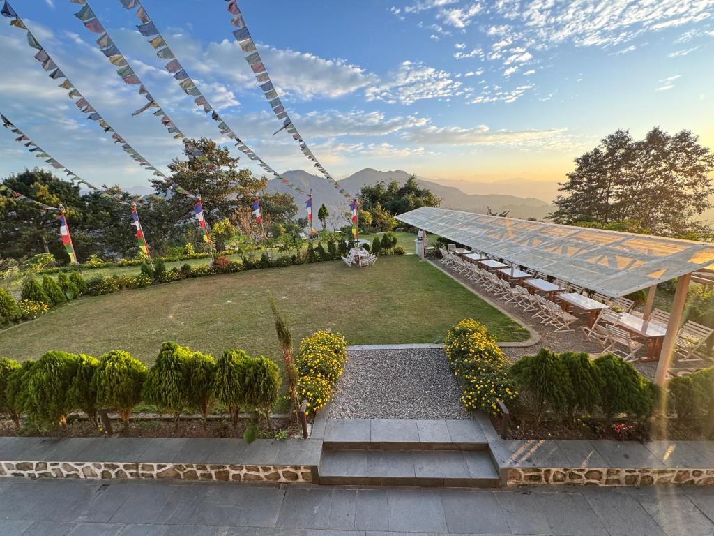 a view of a garden with a table and benches at Sherpa Hills in Kathmandu