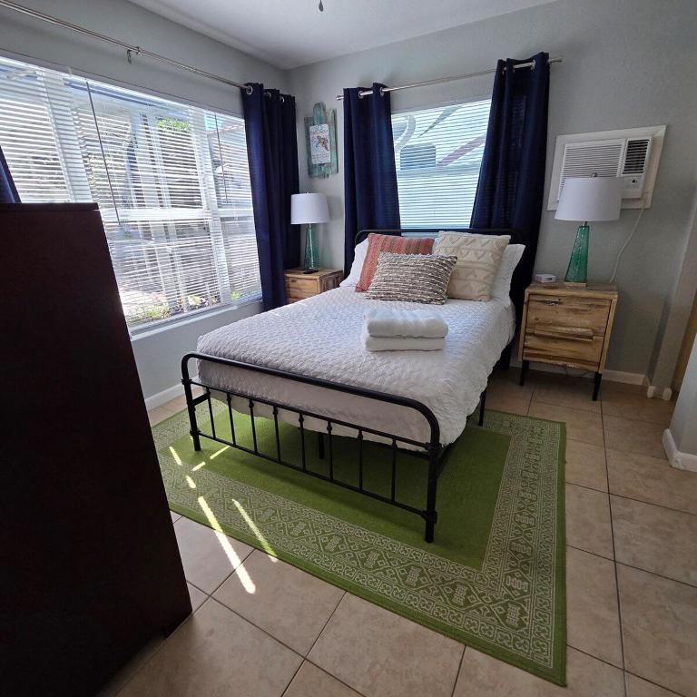 a bedroom with a bed and a window at Largo Pool House Firepit Pet Friendly in Largo