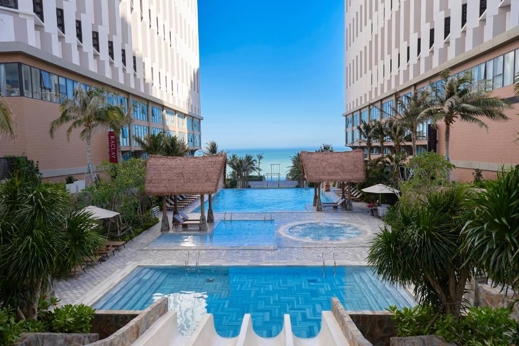 a swimming pool in the middle of a building at The Seafront Condotel - Apec Mandala in Mui Ne