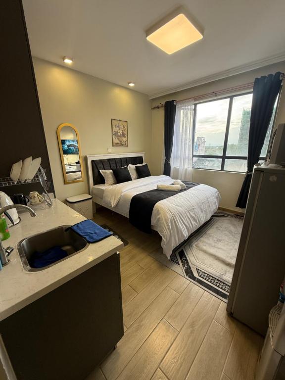 Ένα ή περισσότερα κρεβάτια σε δωμάτιο στο InDesign Makumbi apartments