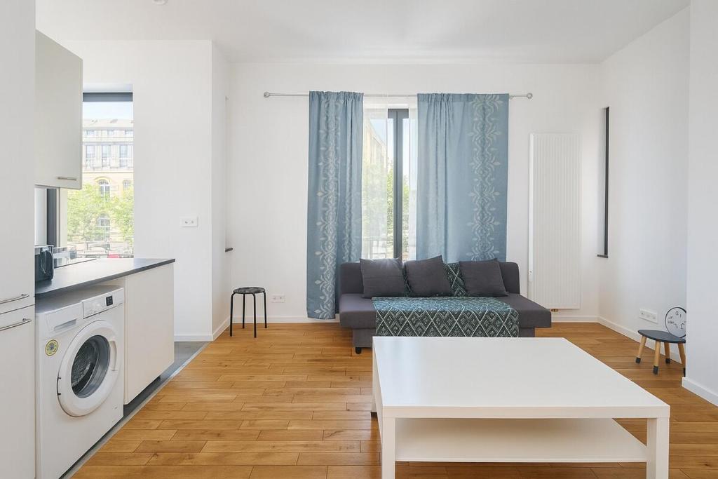 a living room with a couch and a table at Cozy Brabanconne apartment in Brussels