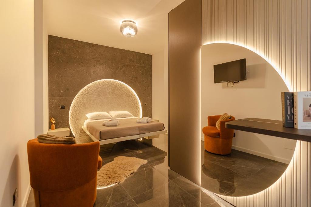 a room with a bed and a table and chairs at VBM Suite & SPA Apartments in Bari
