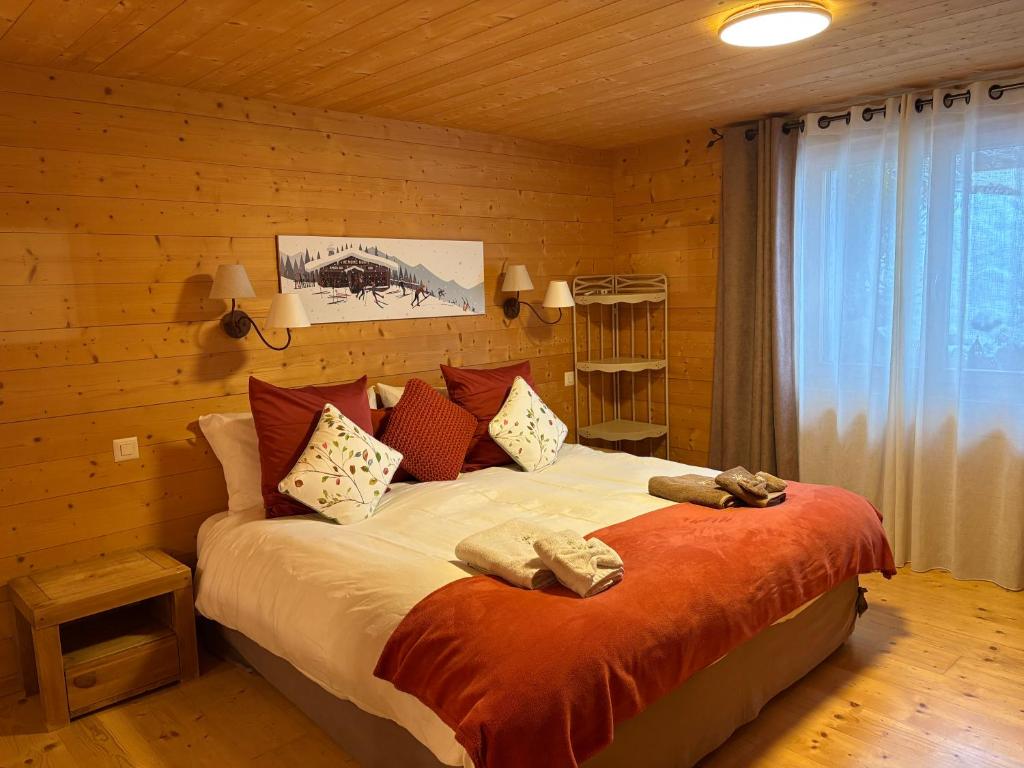 a bedroom with a large bed in a wooden room at Chalet La Renarde in Villars-sur-Ollon