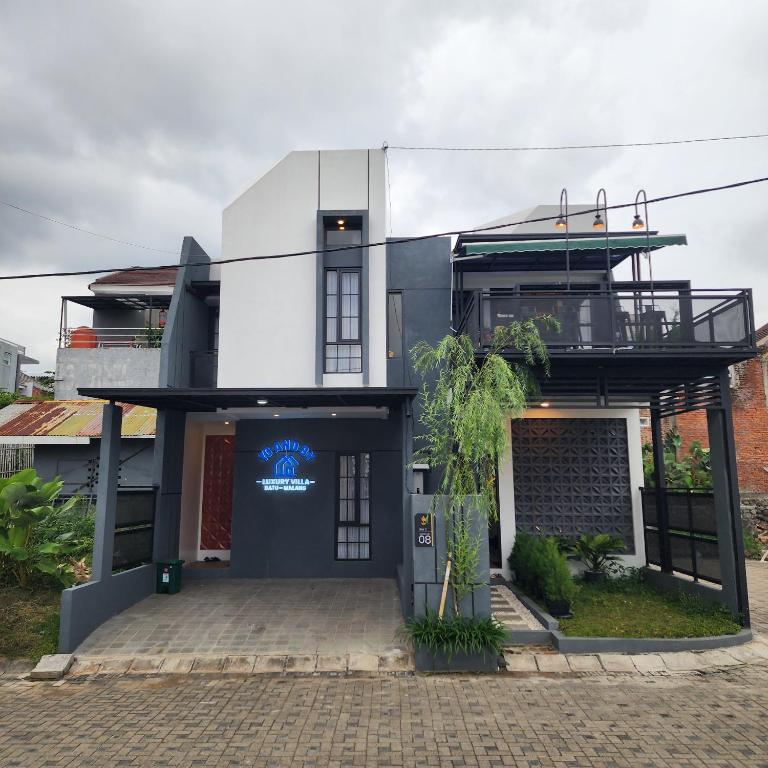 a building with a sign on the front of it at Villa Yo and By in Karangploso
