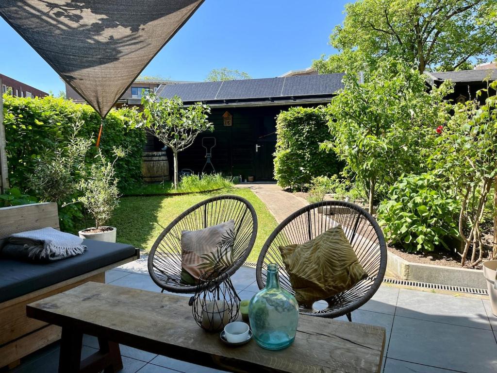 a patio with two chairs and a table at The Cozy Nest in Arnhem