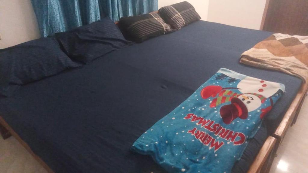 a bed with a sesame street blanket on it at Dev And Ganga Homes in Trichūr