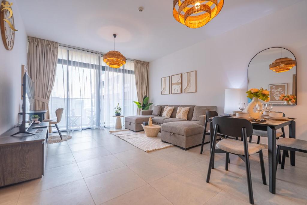 a living room with a couch and a table at Stylish 1BR with Private Balcony Saadiyat Stay in Abu Dhabi