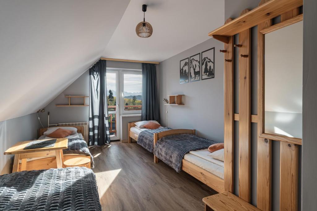 Кровать или кровати в номере Pensjonat Ognisty Wdżar - Velo czorsztyn - CzorsztynSki - Pieniny -Jezioro Czorsztyńskie -