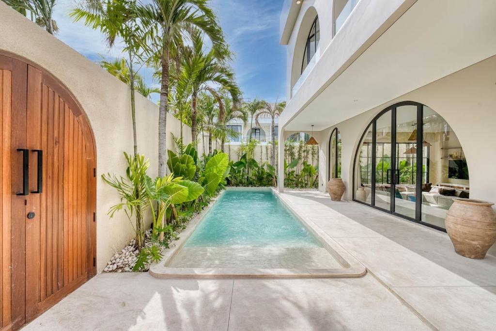 a swimming pool in the middle of a house at Parisian 2BR Luxury Villa 8mins walk to Beach in Bingin Beach