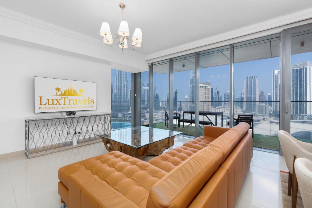a living room with a couch and a table at Boulevard Point I Burj Khalifa Fireworks View in Dubai