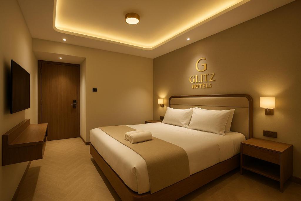 a bedroom with a bed and a sign on the wall at Hotel Mood Premium By Glitz Hotels in Vasai