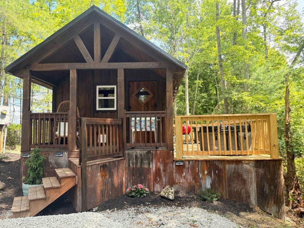 a wooden out house with a gate and a fence at Adventurer's Nook in High Falls