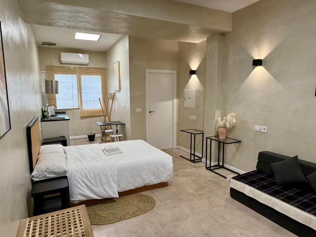 a bedroom with a bed and a couch in it at Suite N25 in Madrid