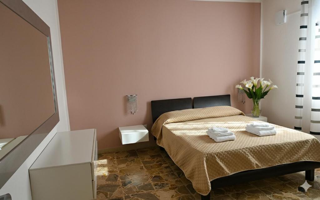 a bedroom with a bed with two towels on it at Casa della Fortuna in San Miniato