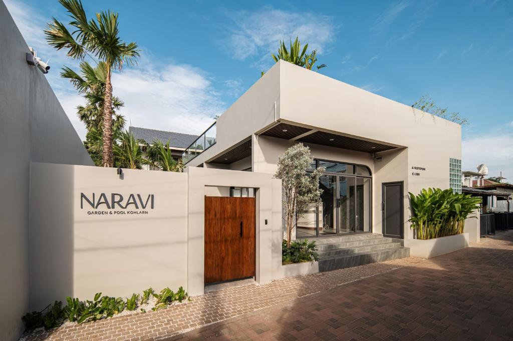 a white house with a nryan sign on it at naravi gardenandpool kohlarn in Ko Sak