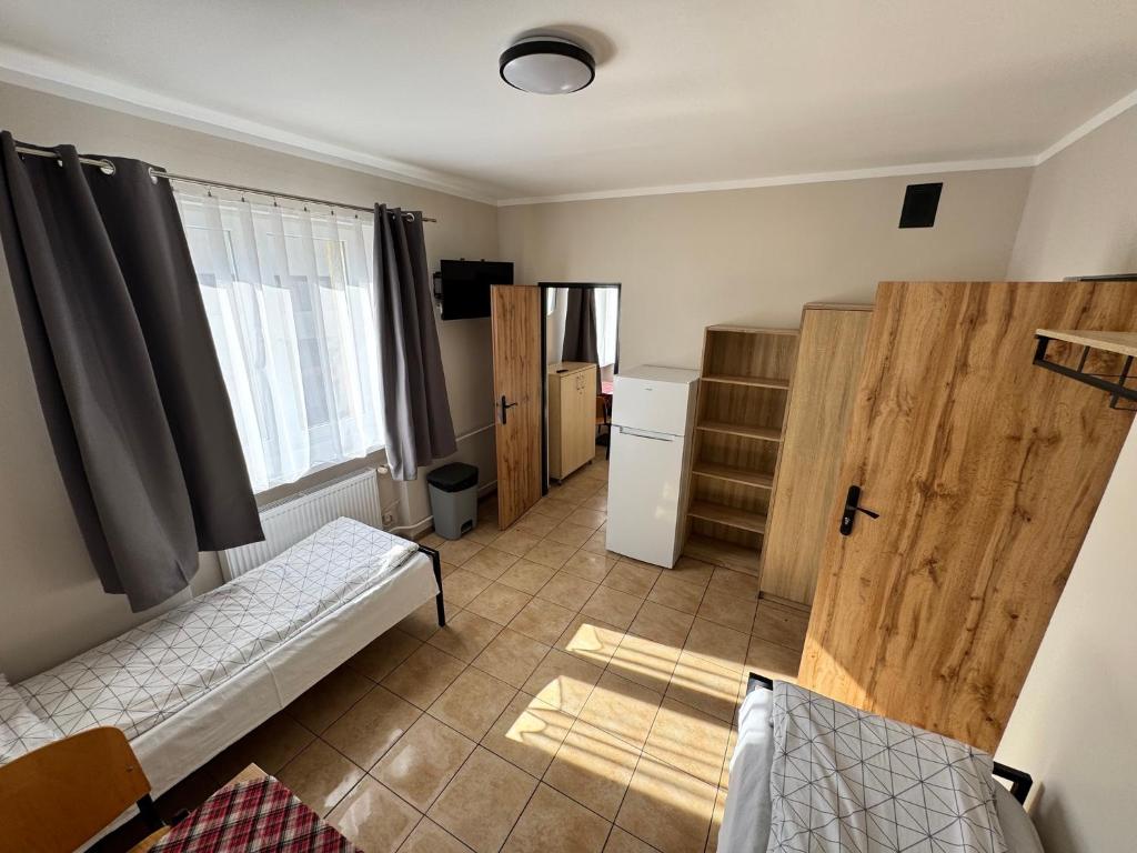 Ένα ή περισσότερα κρεβάτια σε δωμάτιο στο Relaks Noclegi