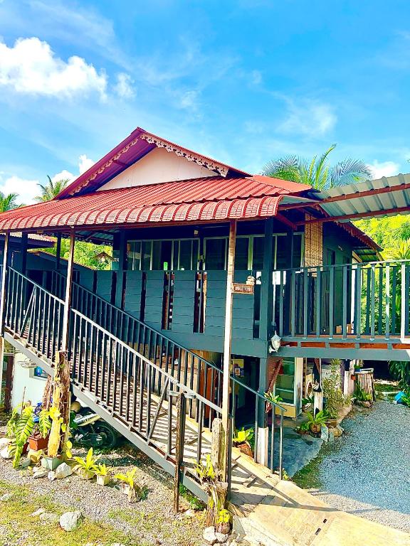 a house with a red roof and a balcony at Rumah Kurnia in Kangar