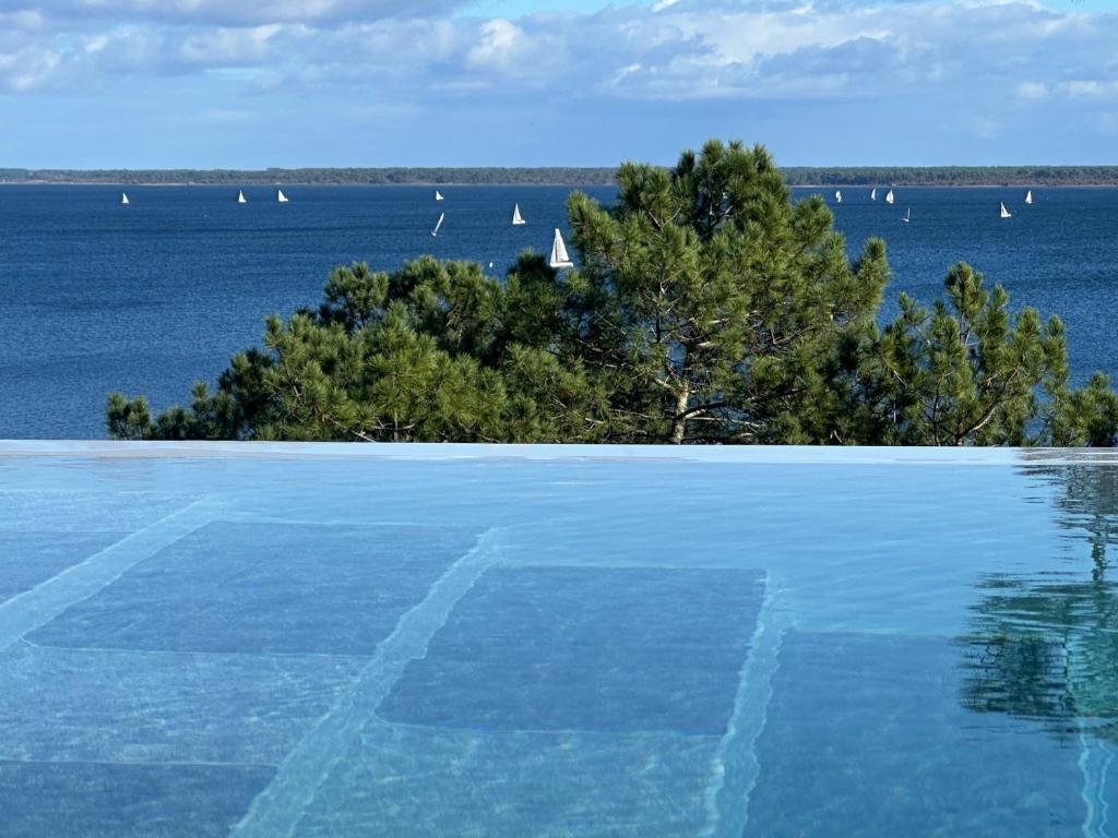ビスカロッスにあるVilla-SONNIER-Biscarrosseの水とボートの景色を望むプール