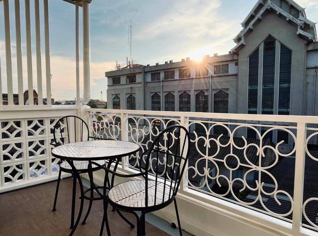 two chairs and a table on a balcony at Excel Hotel Bangkok former Sri Krungthep Hotel in Bangkok