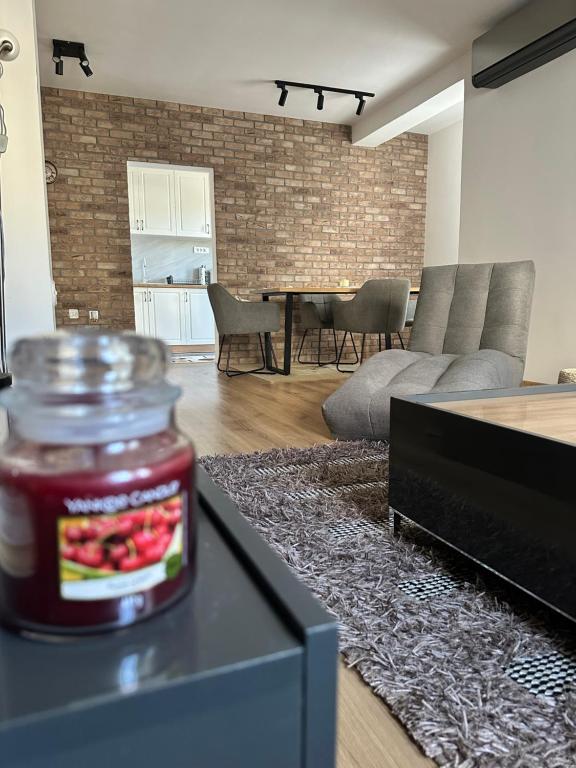 a jar of jam sitting on a table in a living room at Crystal Lux in Veles