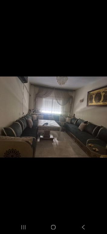 a living room with a couch and a table at Gravereau in Oujda