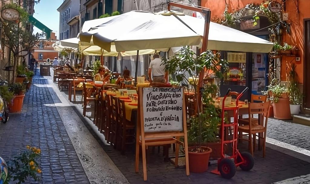 a restaurant with an umbrella and tables and chairs at Residenza dei Papi - Luxury City House in Castel Gandolfo