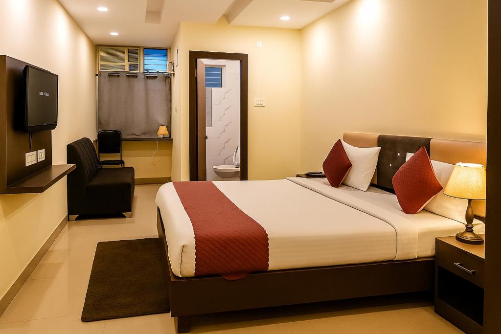 a hotel room with a bed and a television at Vinayaka in Patna