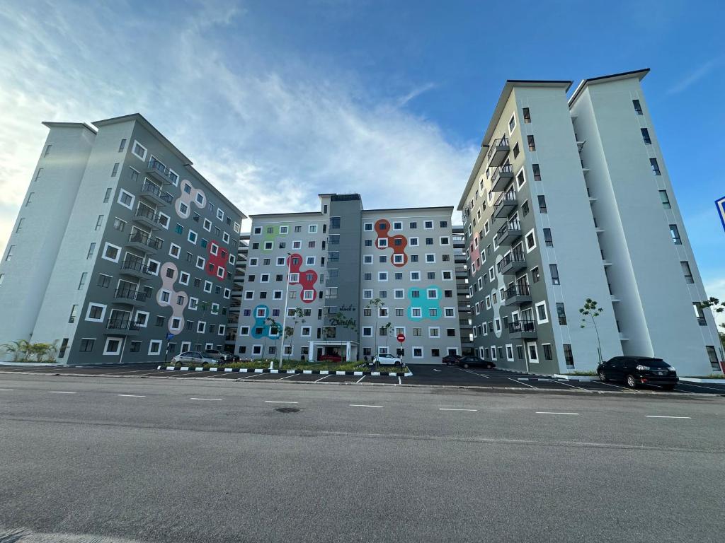 a large apartment building on the side of a street at Kuntum Homestay in Seri Iskandar