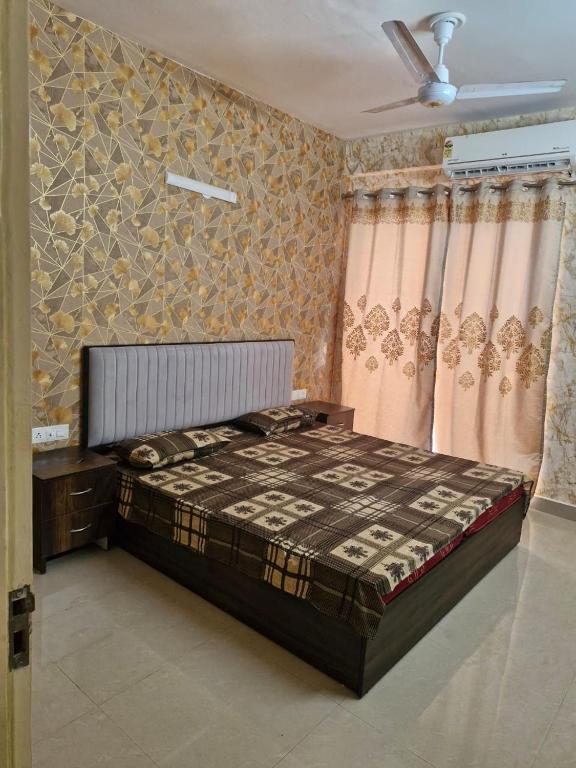 a bedroom with a bed and a ceiling fan at My Private Space in Ludhiana