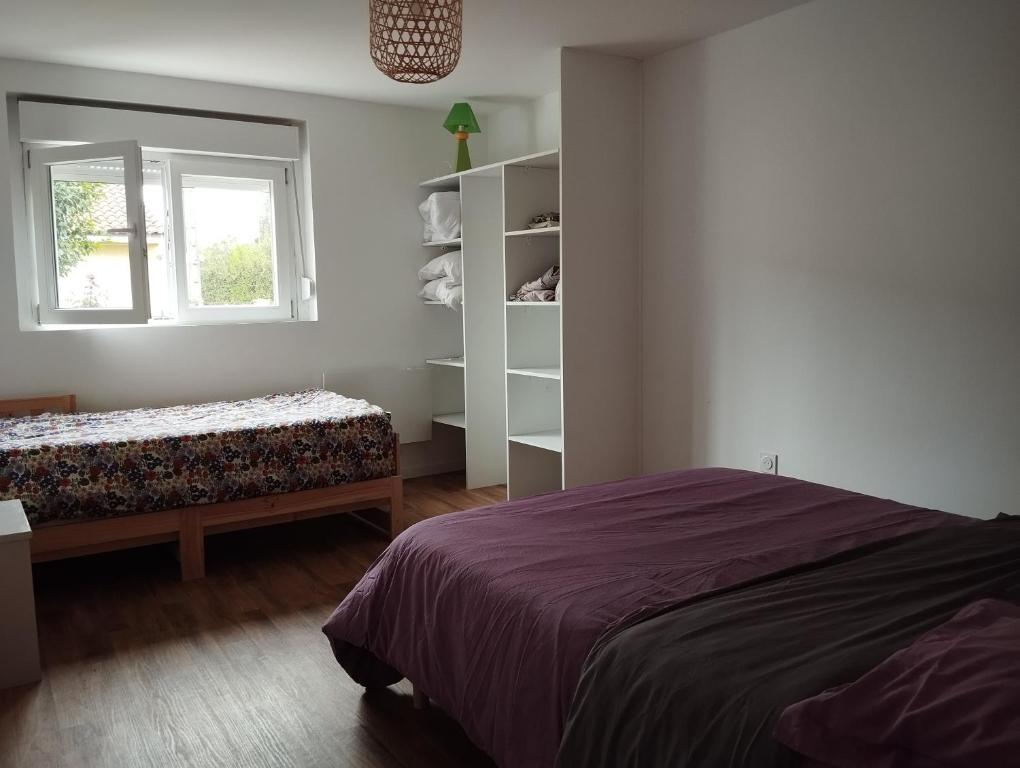 a bedroom with a bed and a window at Appartement Saint Sulpice la Pointe in Saint-Sulpice