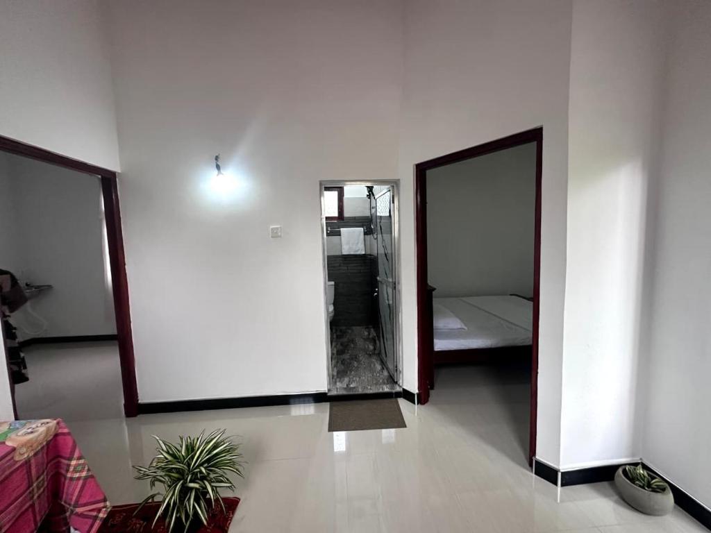 a room with a mirror and a bed in it at Yasiru Villa in Weligama
