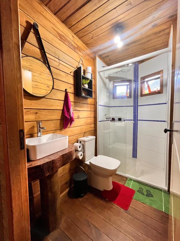a bathroom with a toilet and a sink and a shower at Cabana Betari - Petar in Iporanga