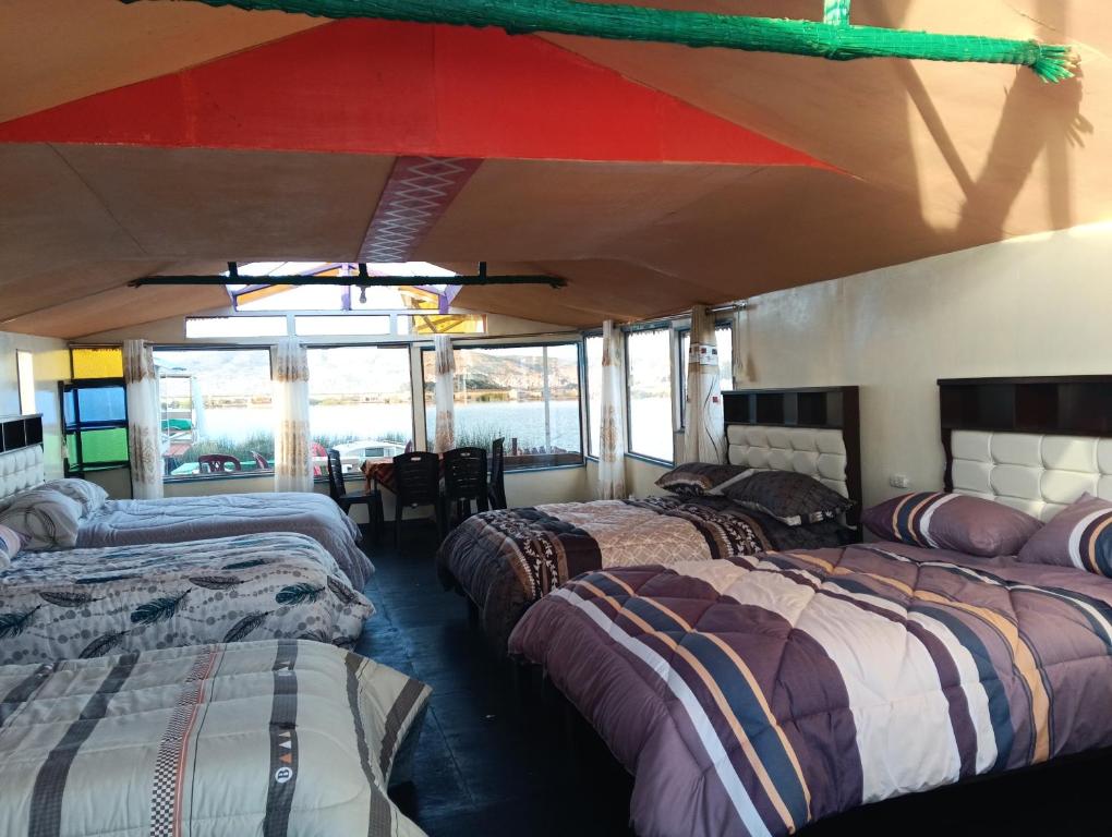 a room with three beds in a bus at casa ecológica in Puno