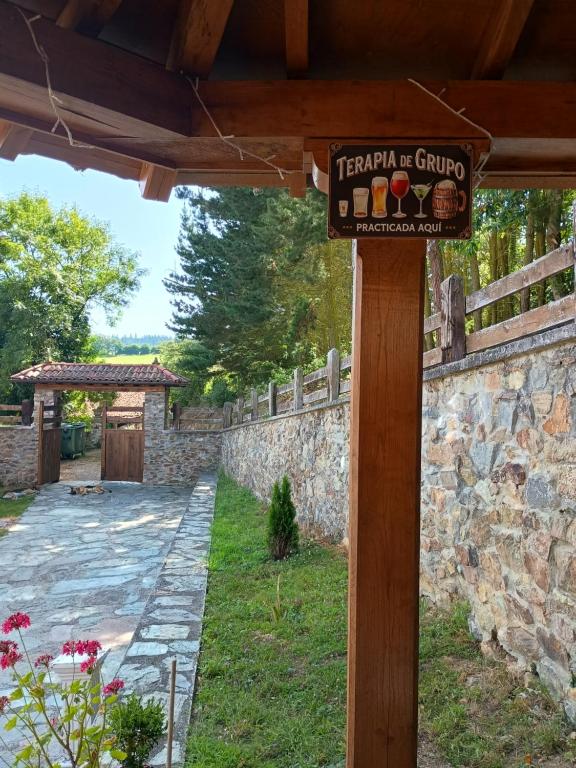 a sign on a wooden pole in a yard at Hotel Rural El Nuevo Semellon Aceptamos Mascotas in La Llama