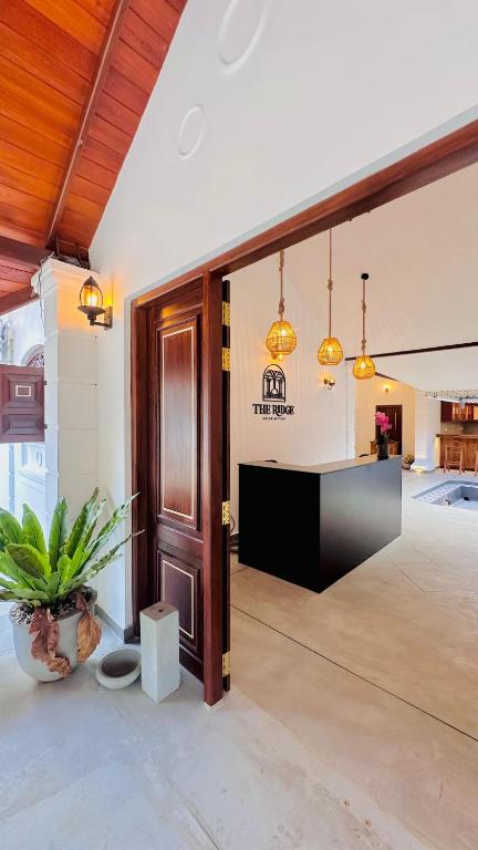 a large room with a door and a table at The Ridge Colonial Villa - Ahangama in Ahangama